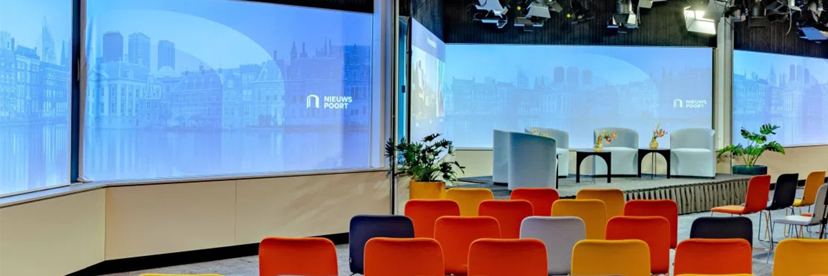 View of a presenter stage with seats at the Nieuwspoort International Press Centre